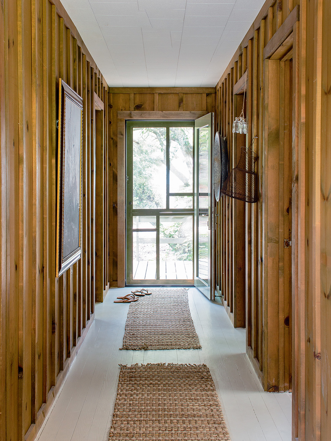 wood paneled hallway with flip flops