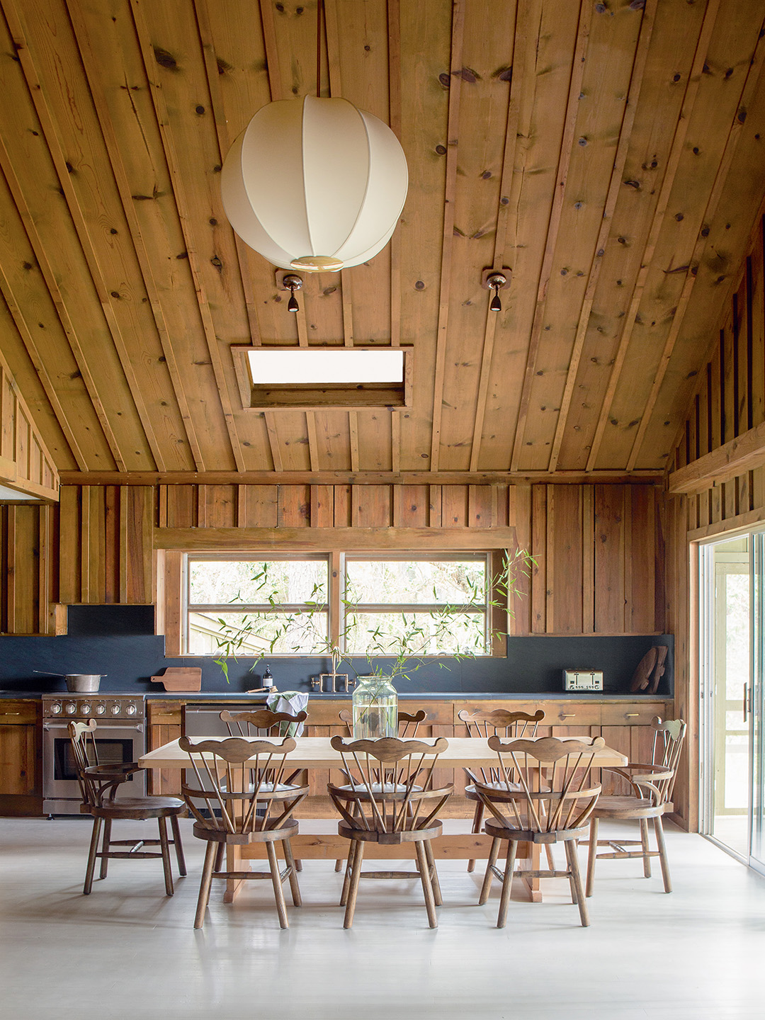 wood paneled kitchen with table and chairs