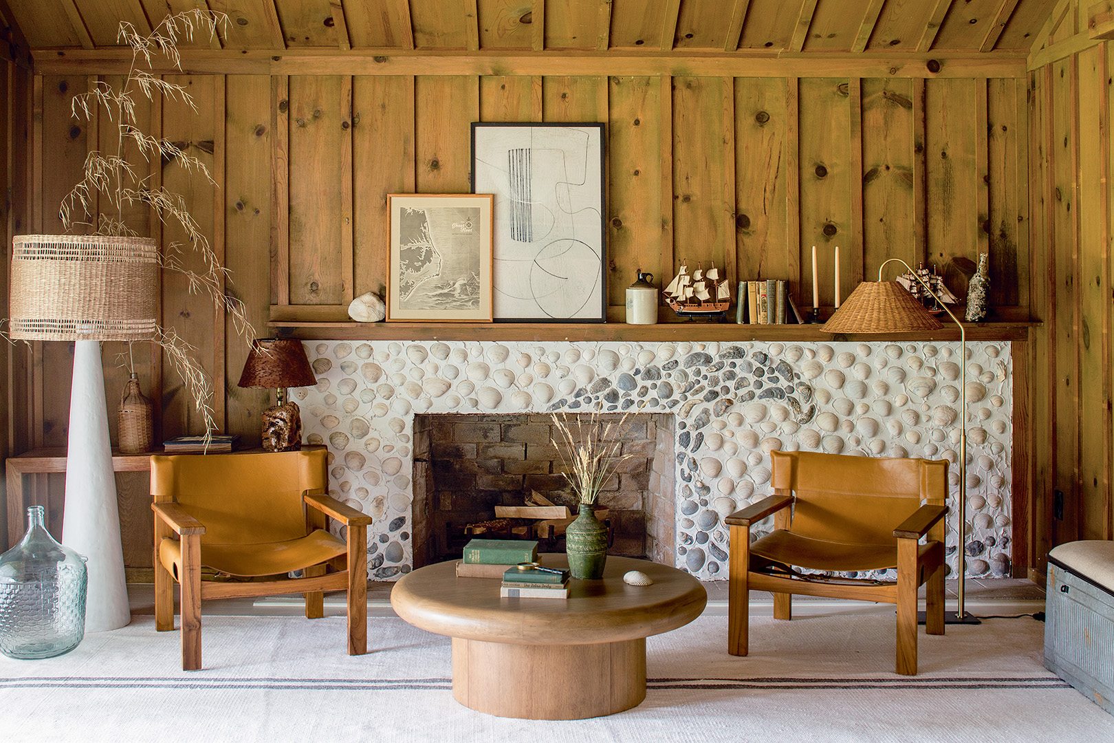 wood paneled living room with shell fireplace