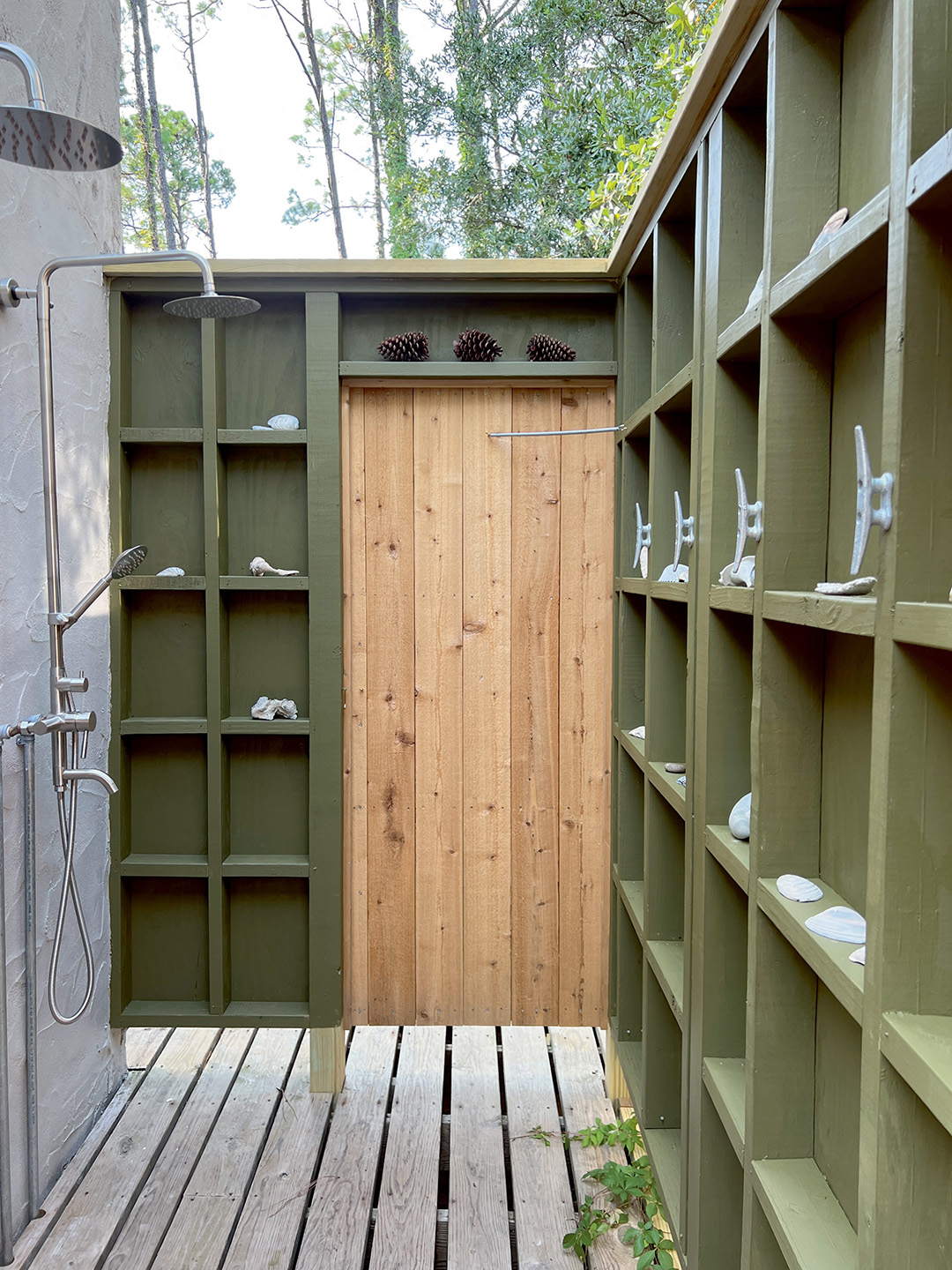 green outdoor shower with shelves