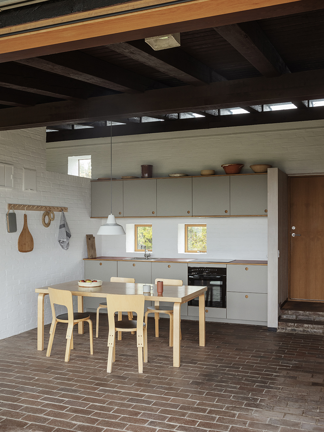 gray kitchen with brick walls