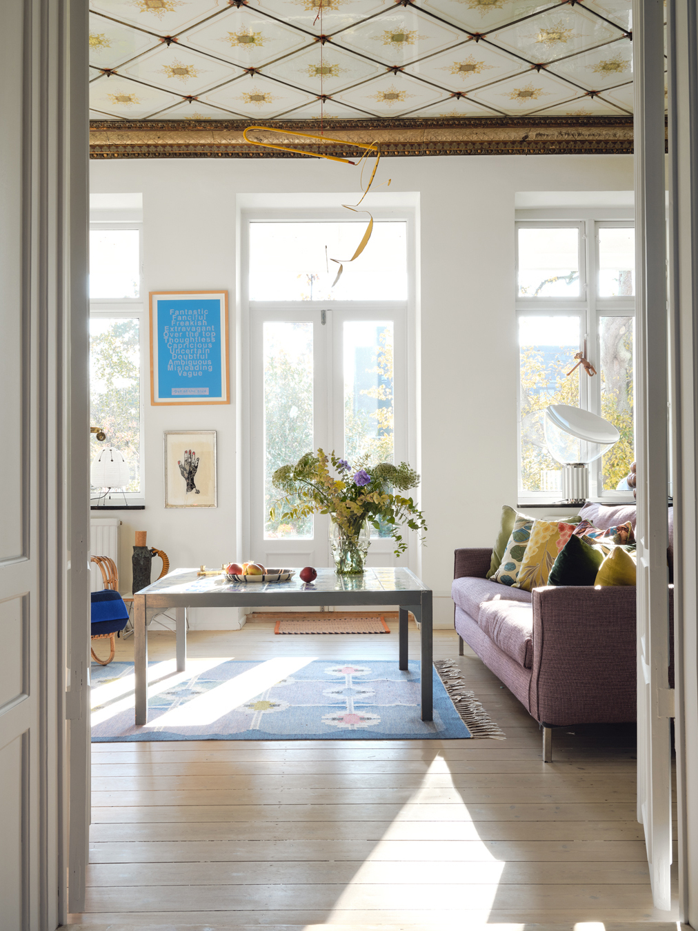 eclectic living room with purple sofa