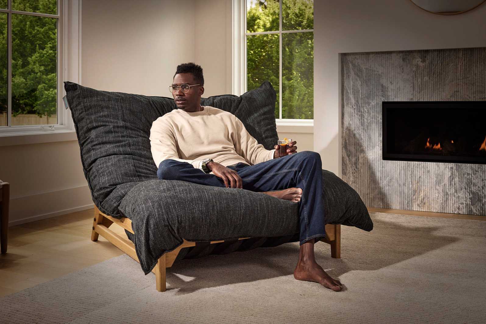 Man sitting on pillowsac chair in charcoal