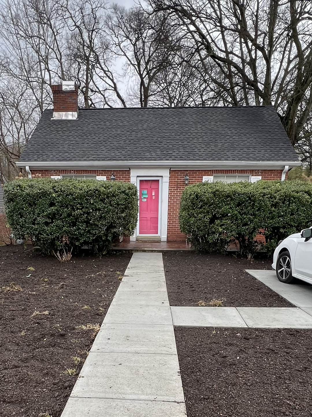 Front of house with sidewalk and dirt