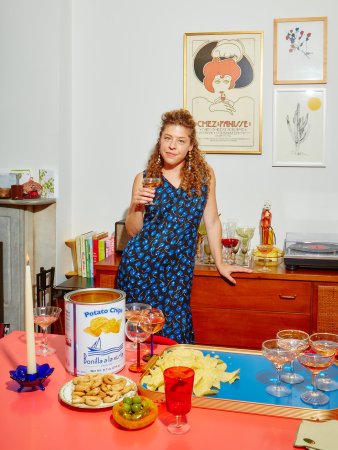 Woman in blue dress holding cocktail