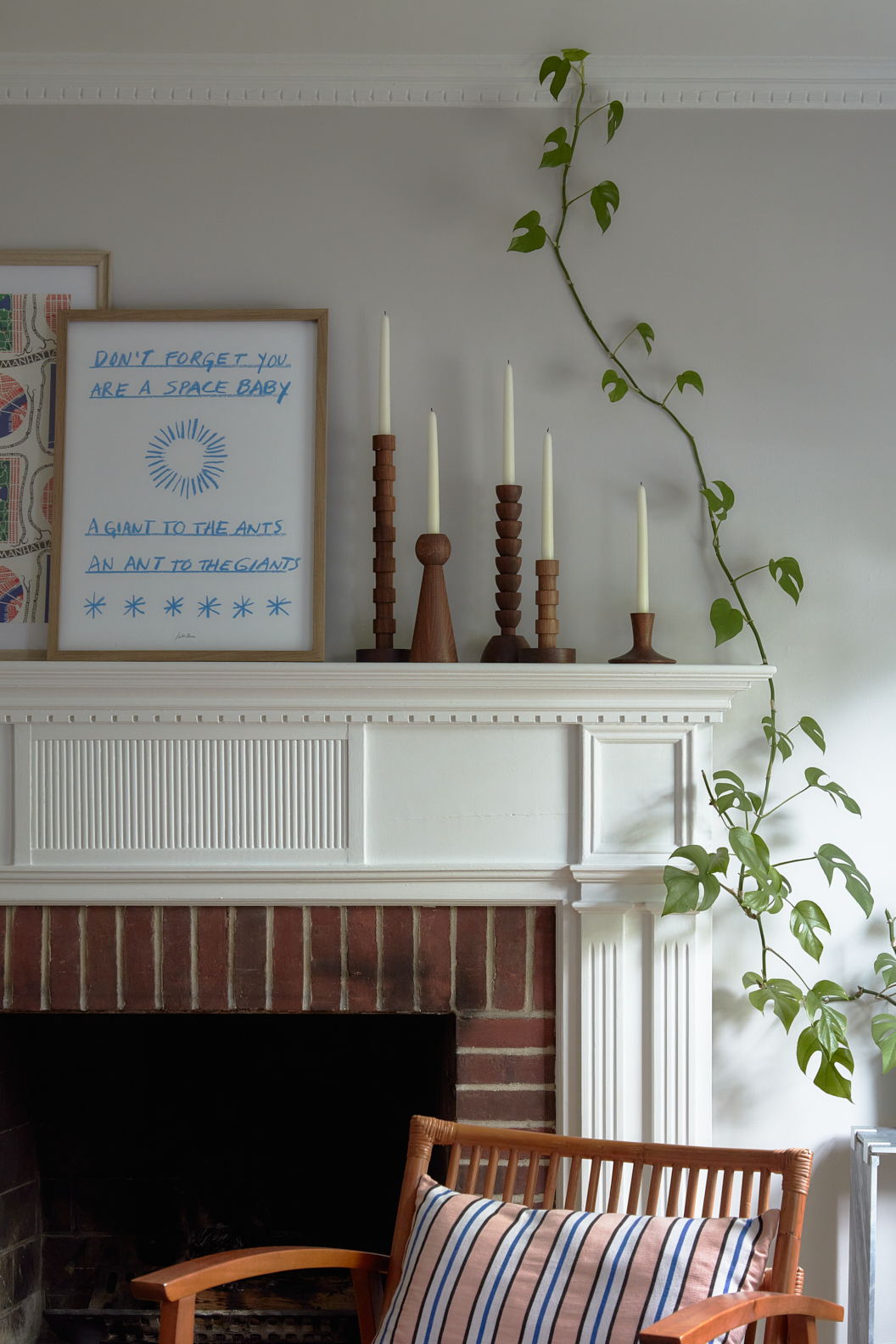 white fireplace with wood candlesticks