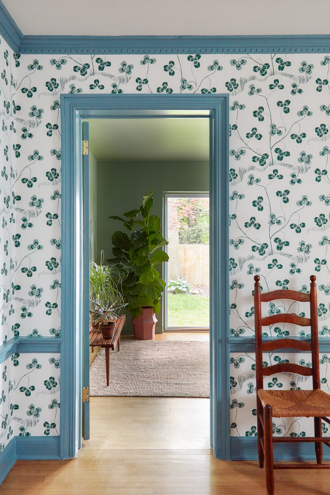 dining room with clover wallpaper and blue trim