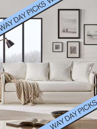 white slipcover sofa with gallery wall above