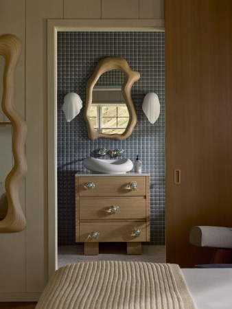 bathroom with sculptural sconces and sink