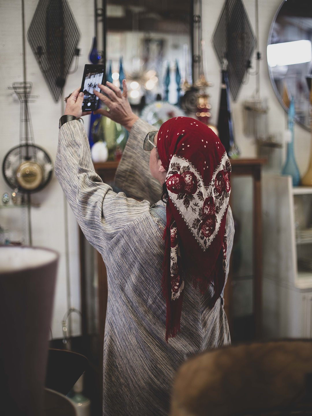 Woman reaching for item at antiques market