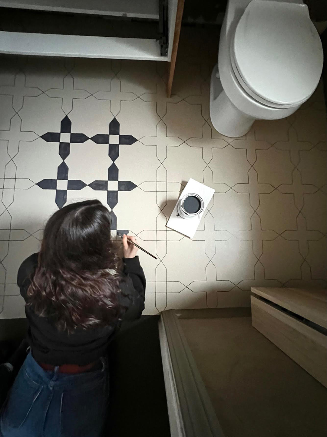 woman stenciling bathroom floor