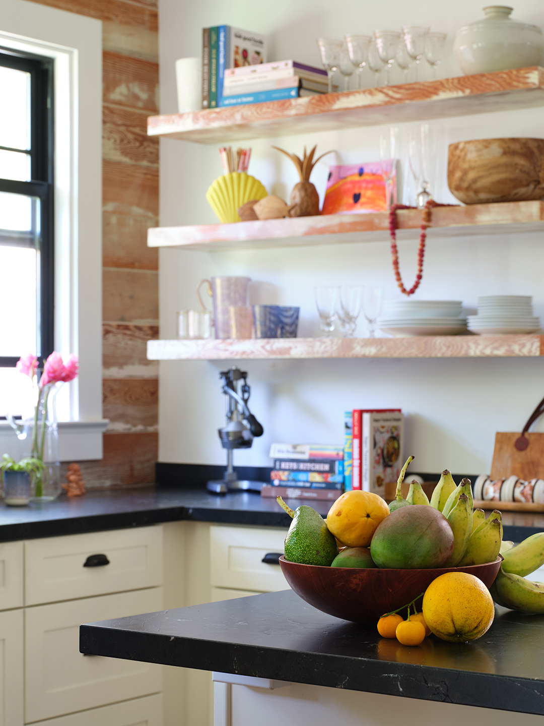 Open shelving in kitchen with bowls and vases