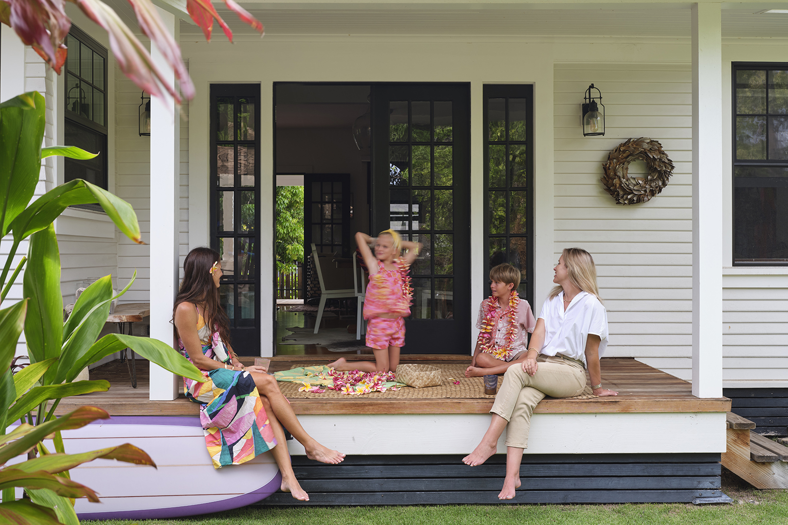 Two women and two kids on porch