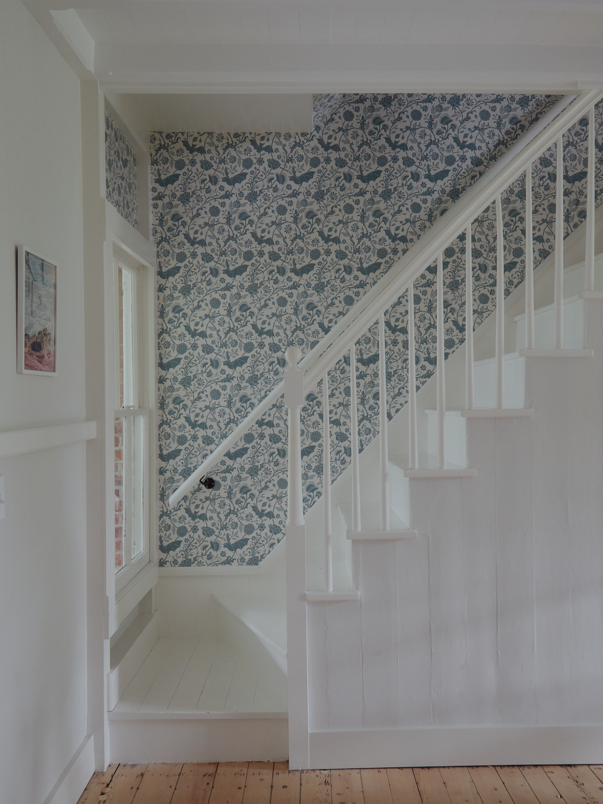 blue patterned wallpaper going upstairs