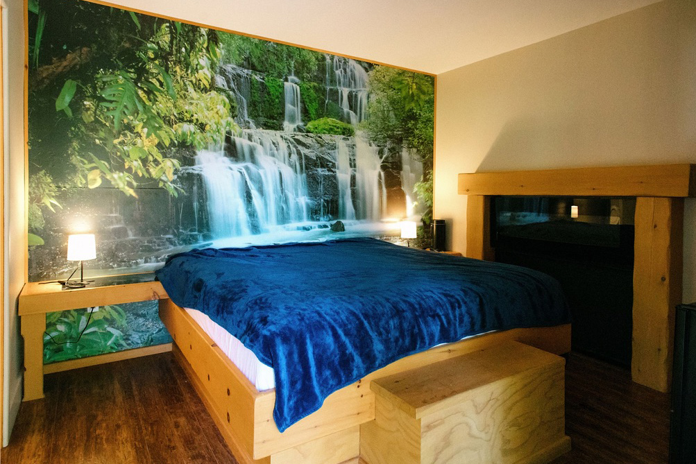 Motel room with a waterfall mural 