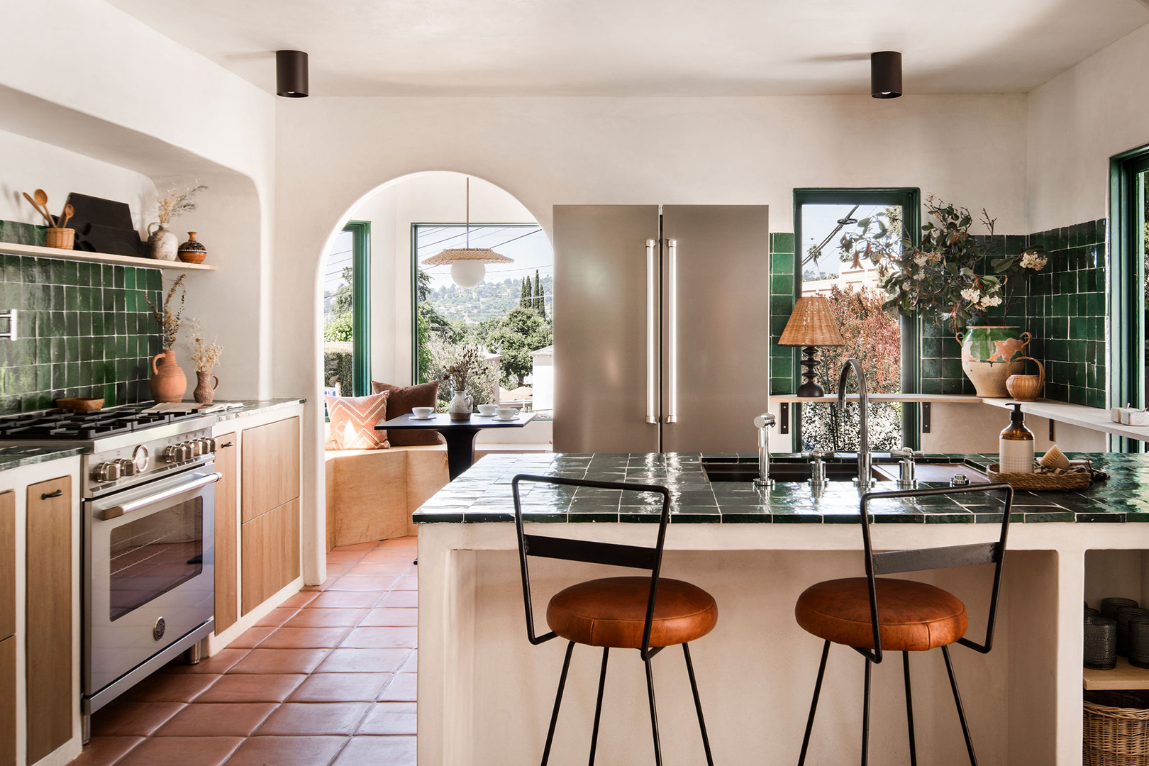 Bar stools with green tiled countertop