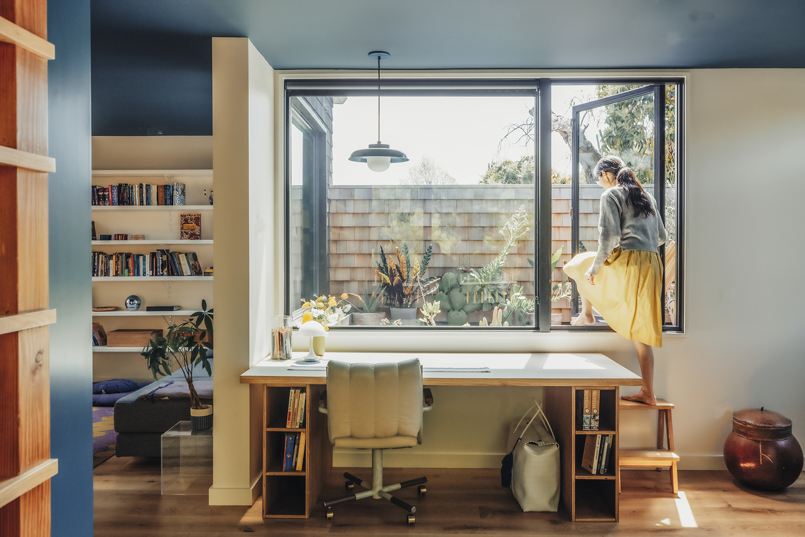 person crawling out through window