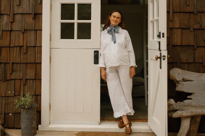 Lacy Phillips in doorway of cabin