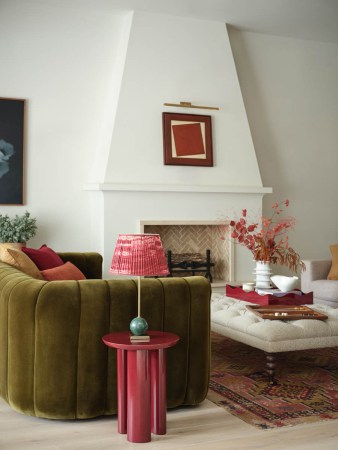 green sofa with art over fireplace