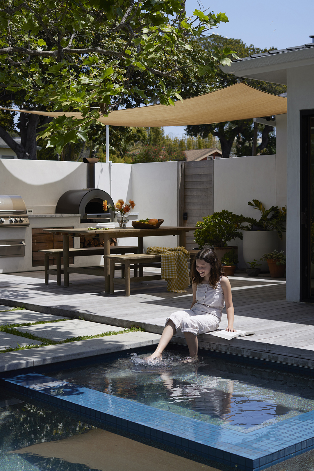 kid with feet in pool