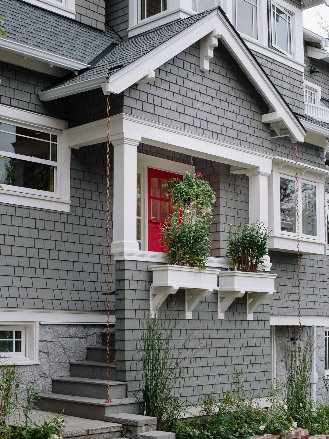 gray house with flower boxes