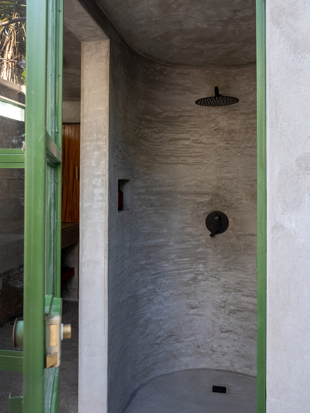 concrete shower with green window panes