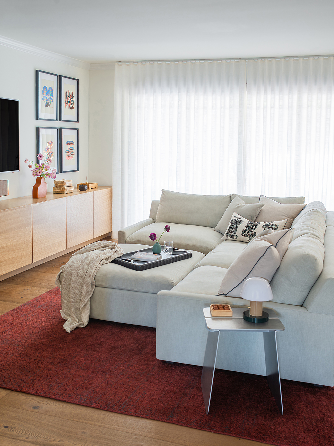 gray sectional on red rug