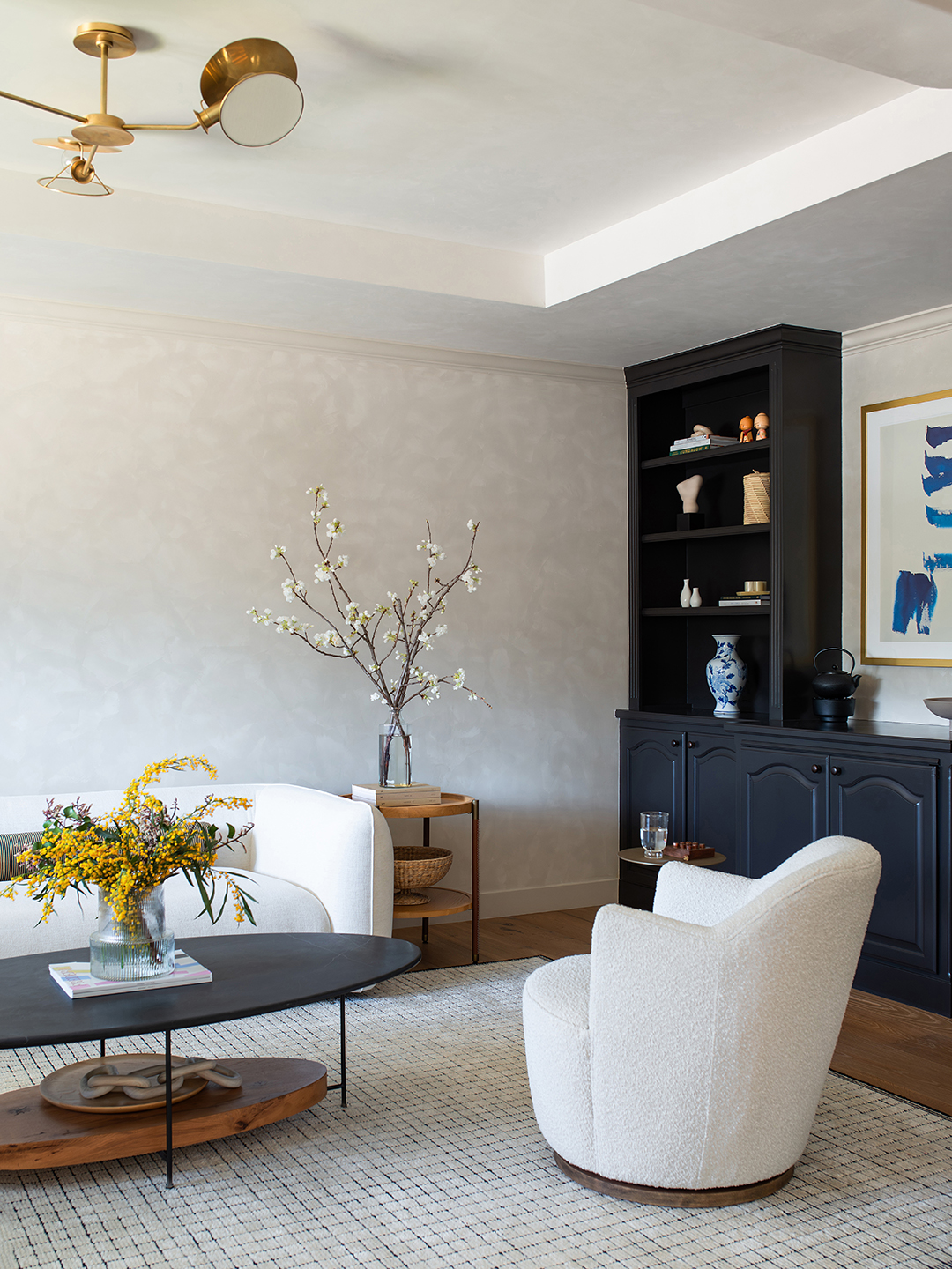 white living room with black bookshelves