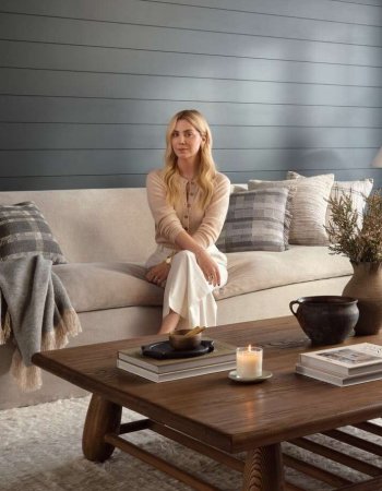 Portrait of Amber Lewis sitting on a sofa