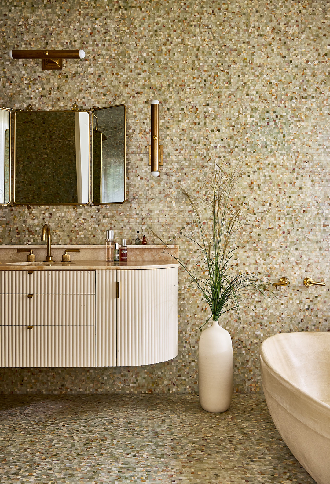 fluted bathroom vanity with mosaic tile backdrop