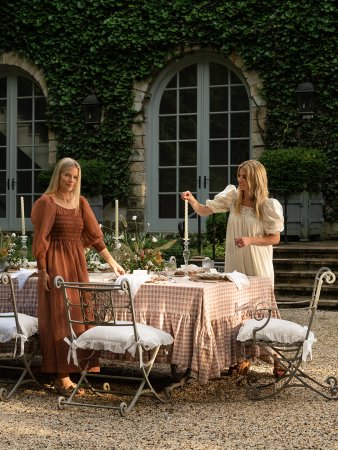 Jessie Randall and Shea McGee in front of outdoor table