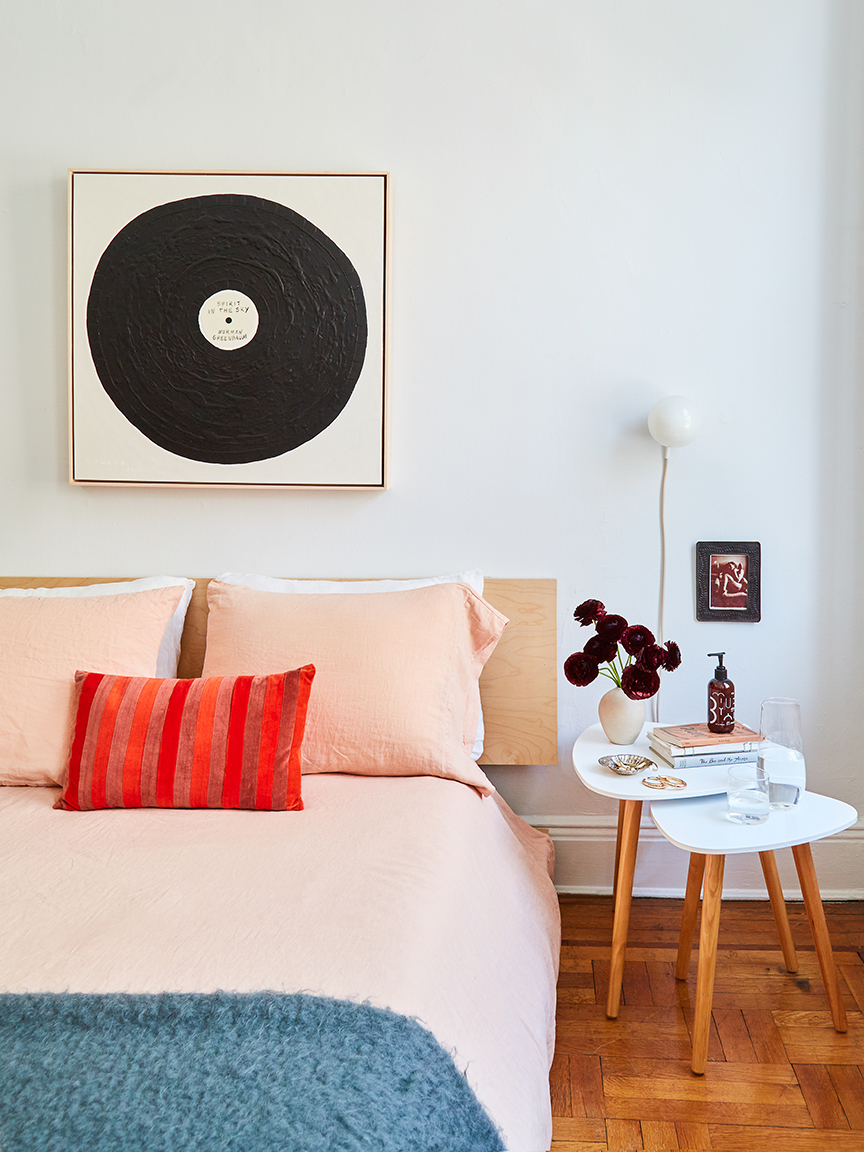 Bed with carafe on bedside table