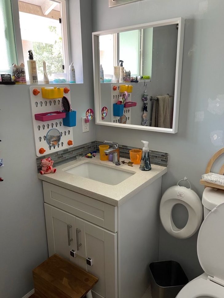 small vanity with kids toys around it