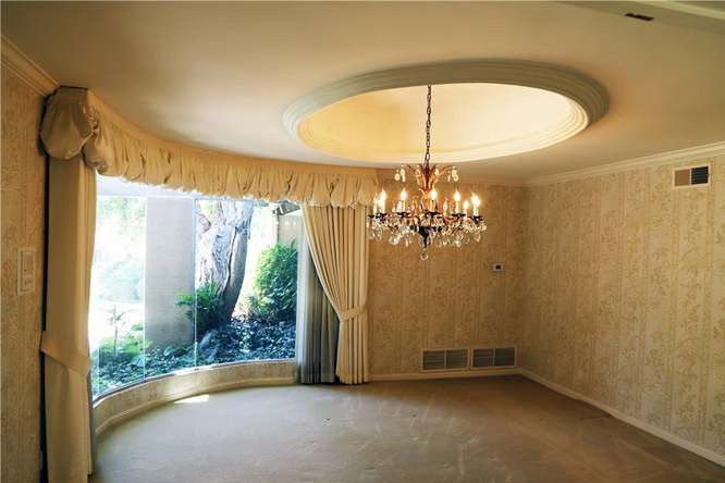 dining room with dated curtains and chandelier