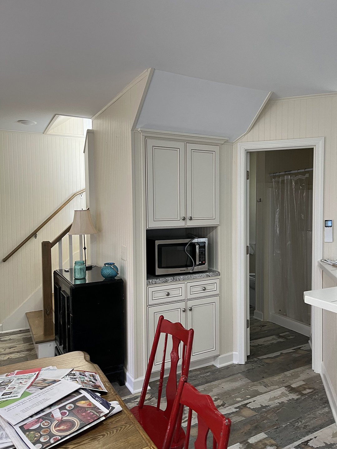 white cabinets under stairs