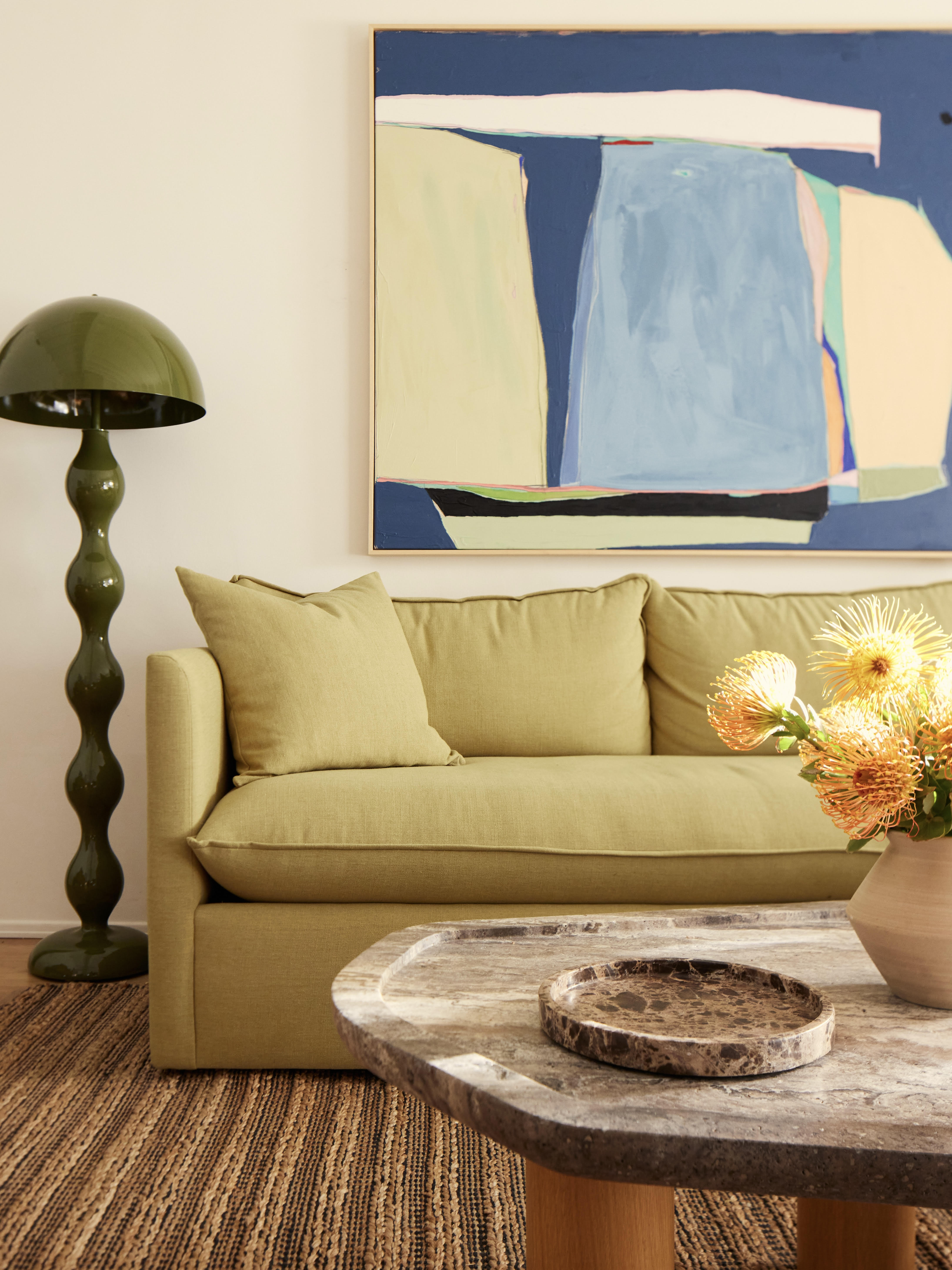 Living room with chartreuse sofa and olive floor lamp