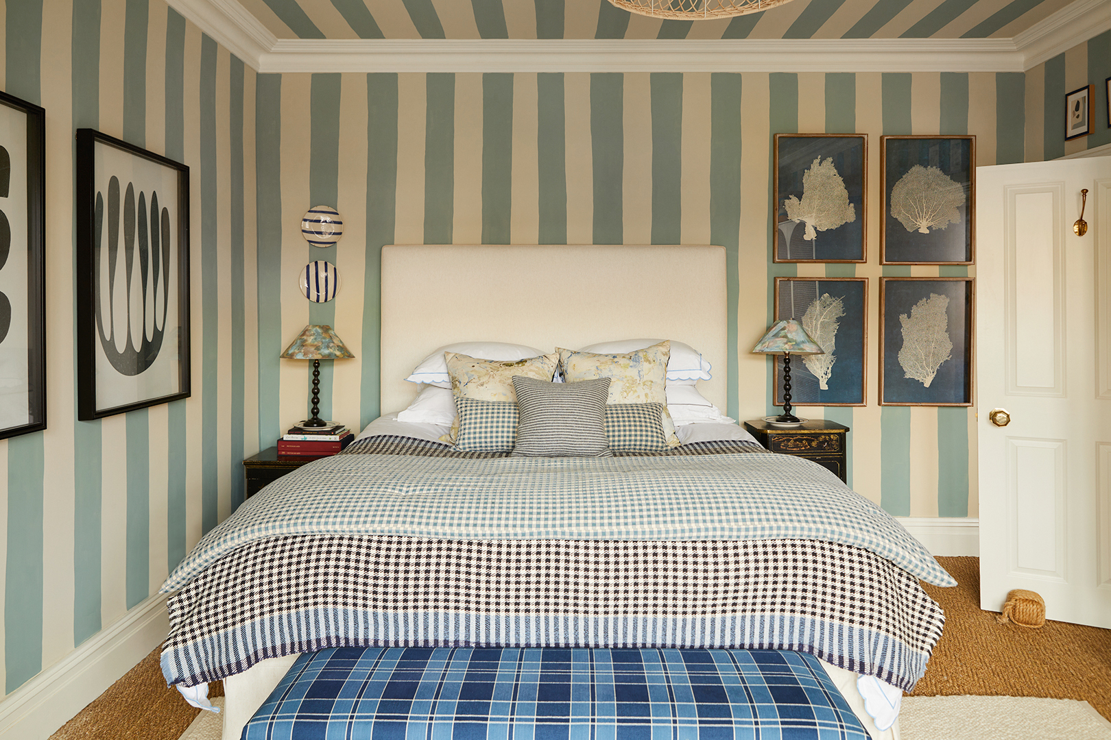 Bedroop with blue and white stripe painted walls and checked bedding