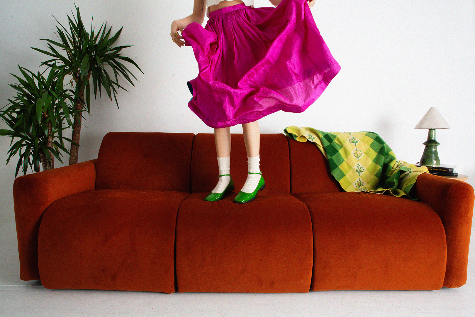 Person jumping on top of sofa