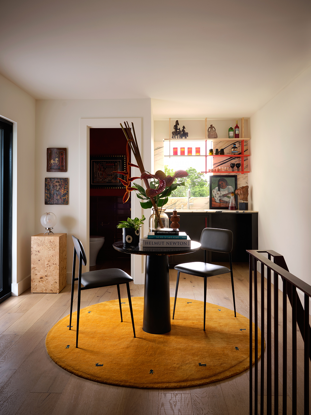 round rug and table at top of stairs