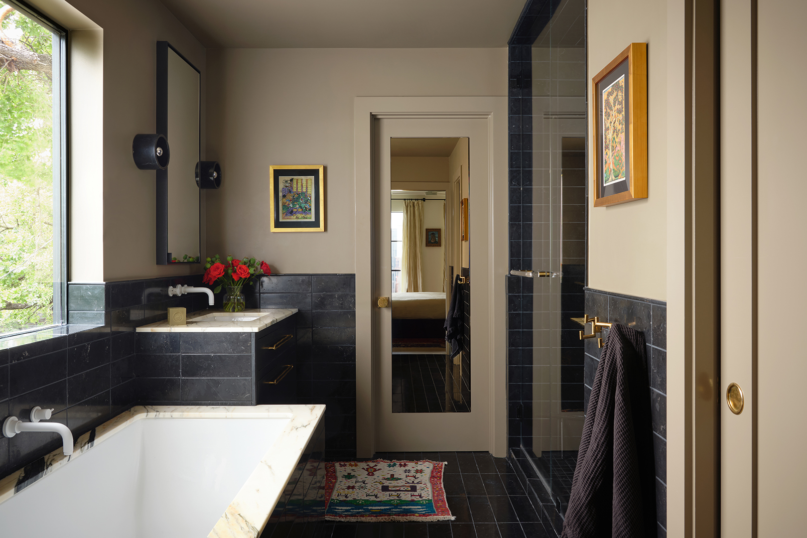 tub with black tile surround