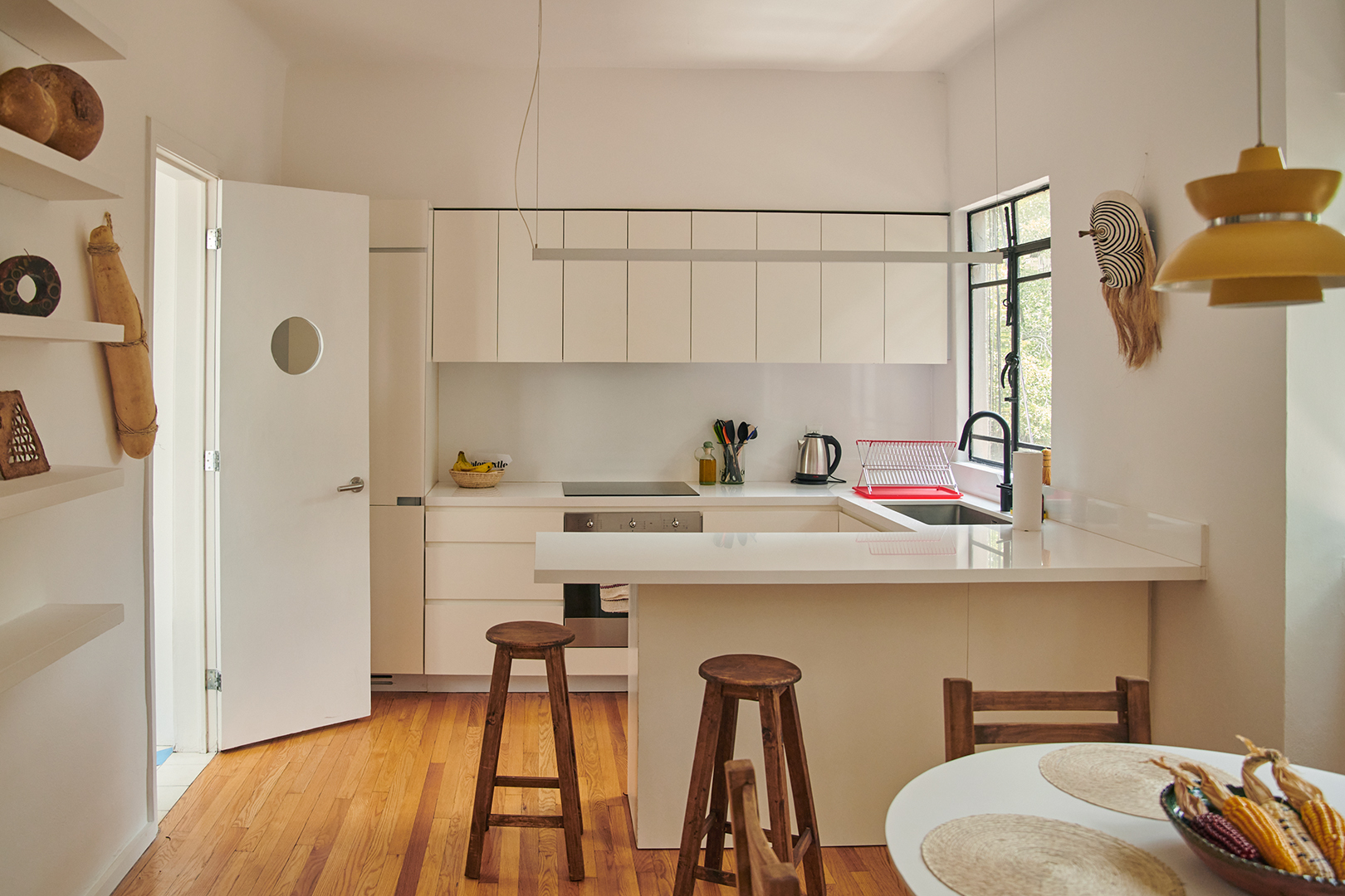 kitchen with white cabinets and wooden stools