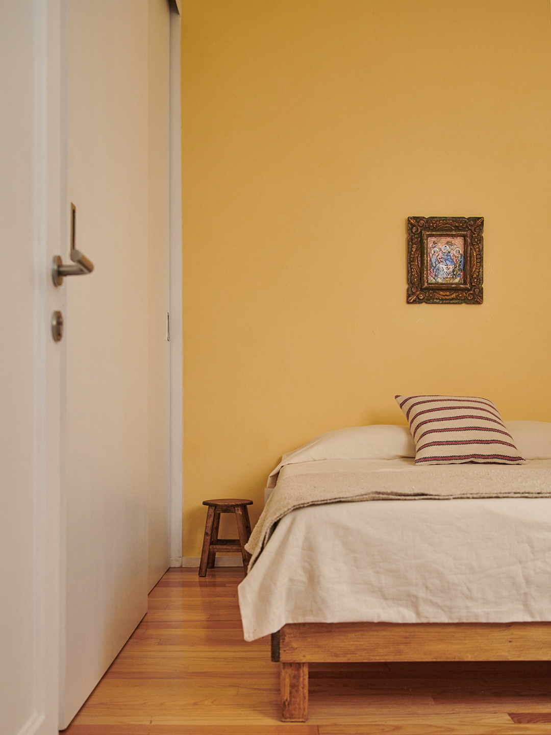 Bedroom with yellow limewash walls and white bedding