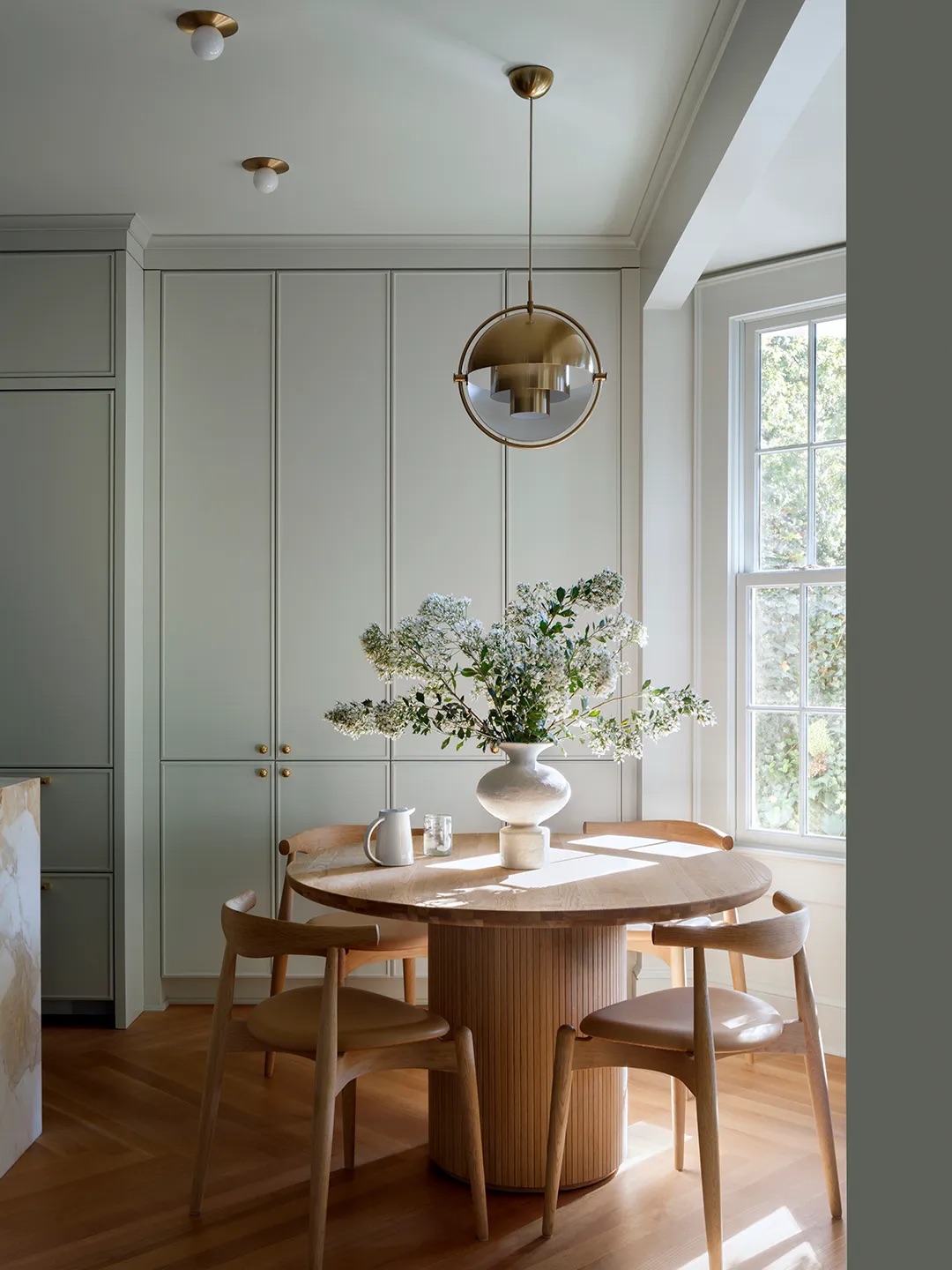 Breakfast nook with green cabinetry