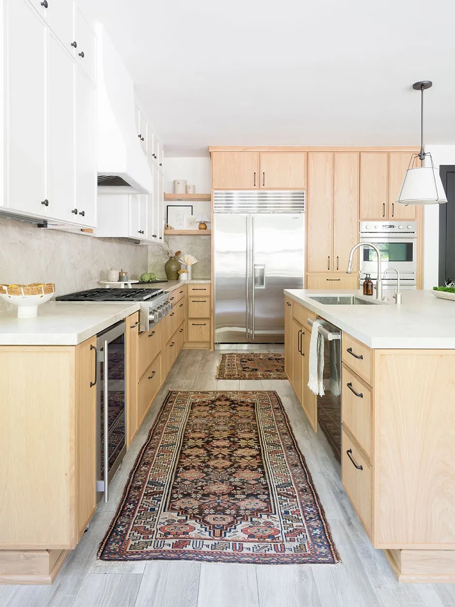 Kitchen with quartzite countertops and oak cabinetry