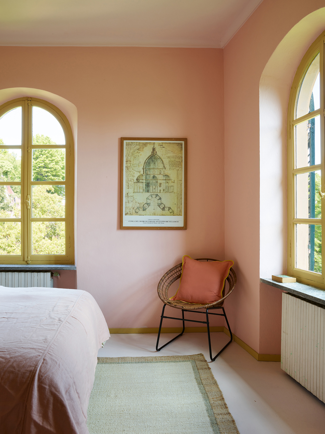 rattan chair in corner of bedroom