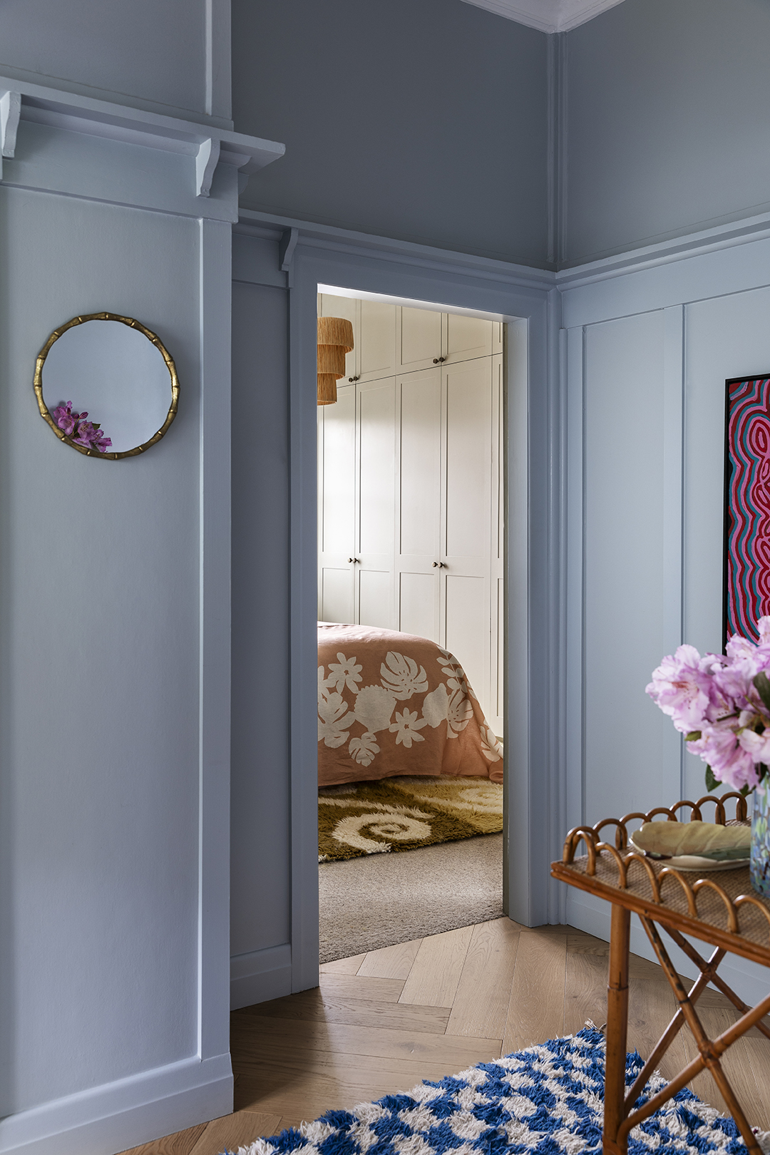 Blue hallway with view to bedroom.