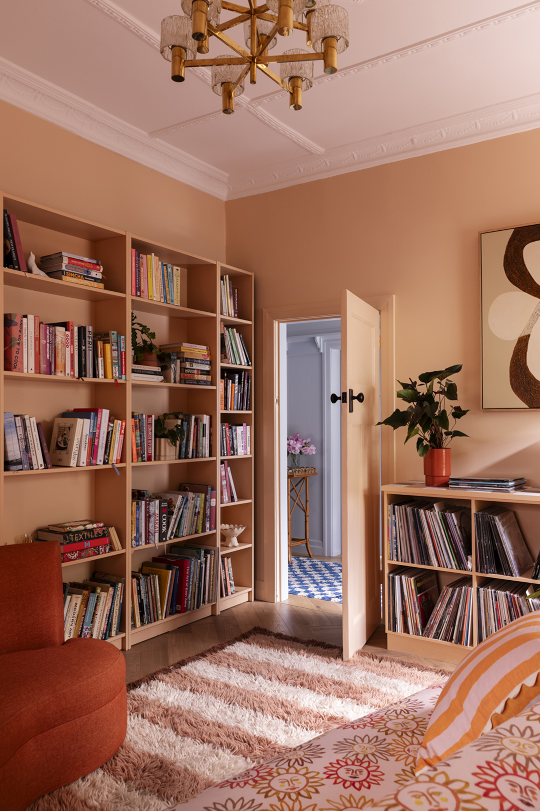 Peach living room with bookshelves.