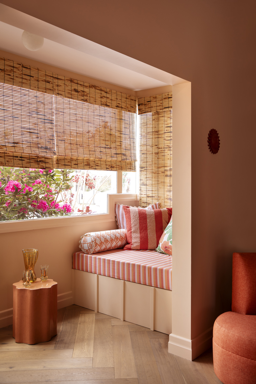 Reading nook with striped cushion.