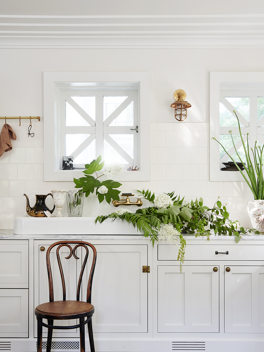 kitchen sink filled with greenery