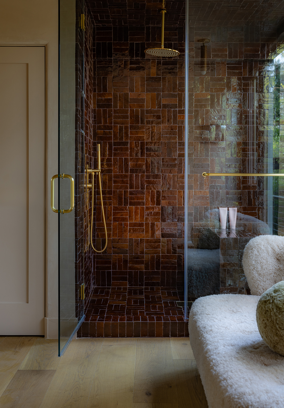 Bathroom shower stall with brown tile in basketweave pattern